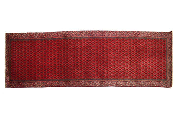 Red patterned rug on a white background