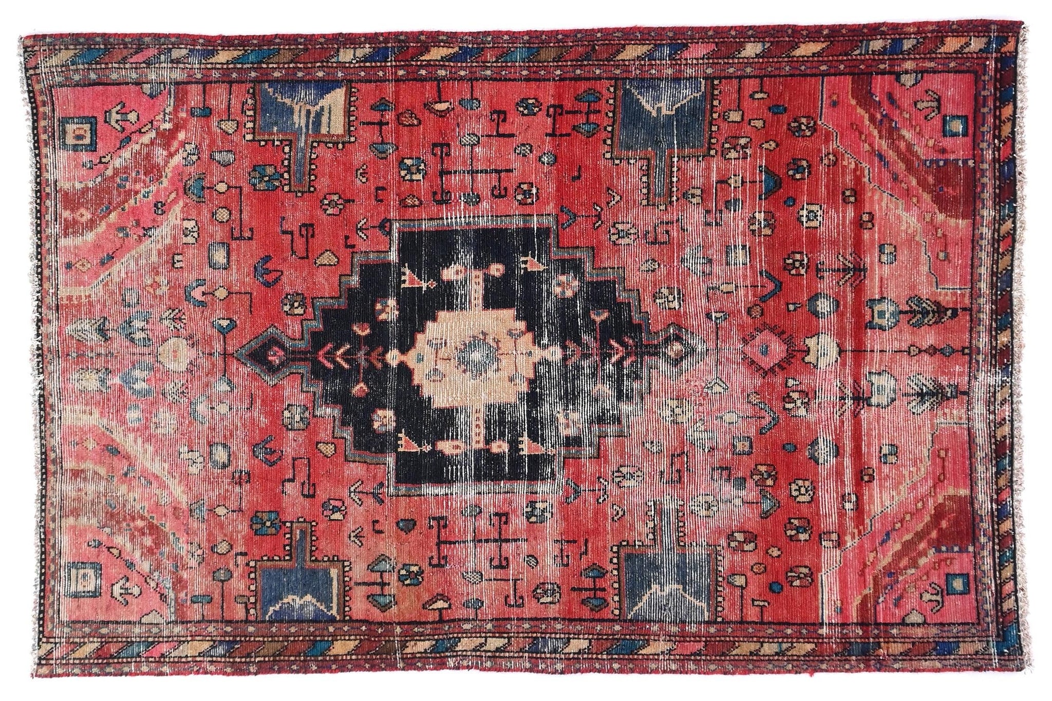Red and black patterned rug on a white background