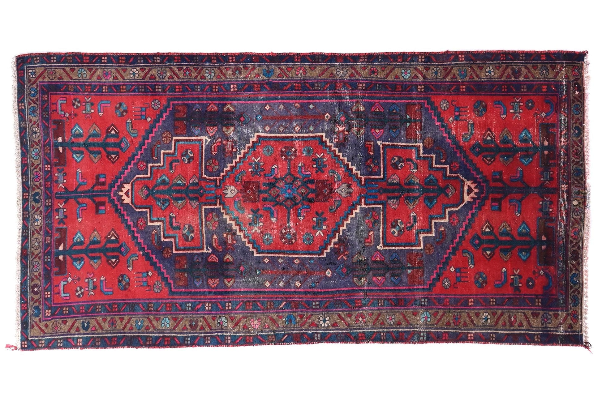Red and blue patterned rug on a white background