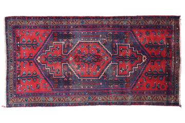 Red and blue patterned rug on a white background