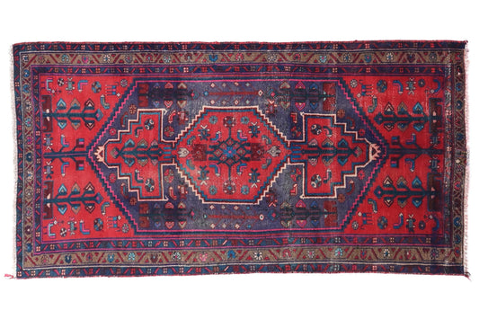 Red and blue patterned rug on a white background
