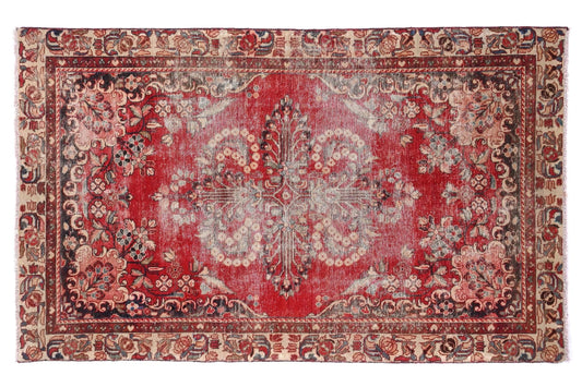 Decorative red and beige rug with intricate patterns on a white background