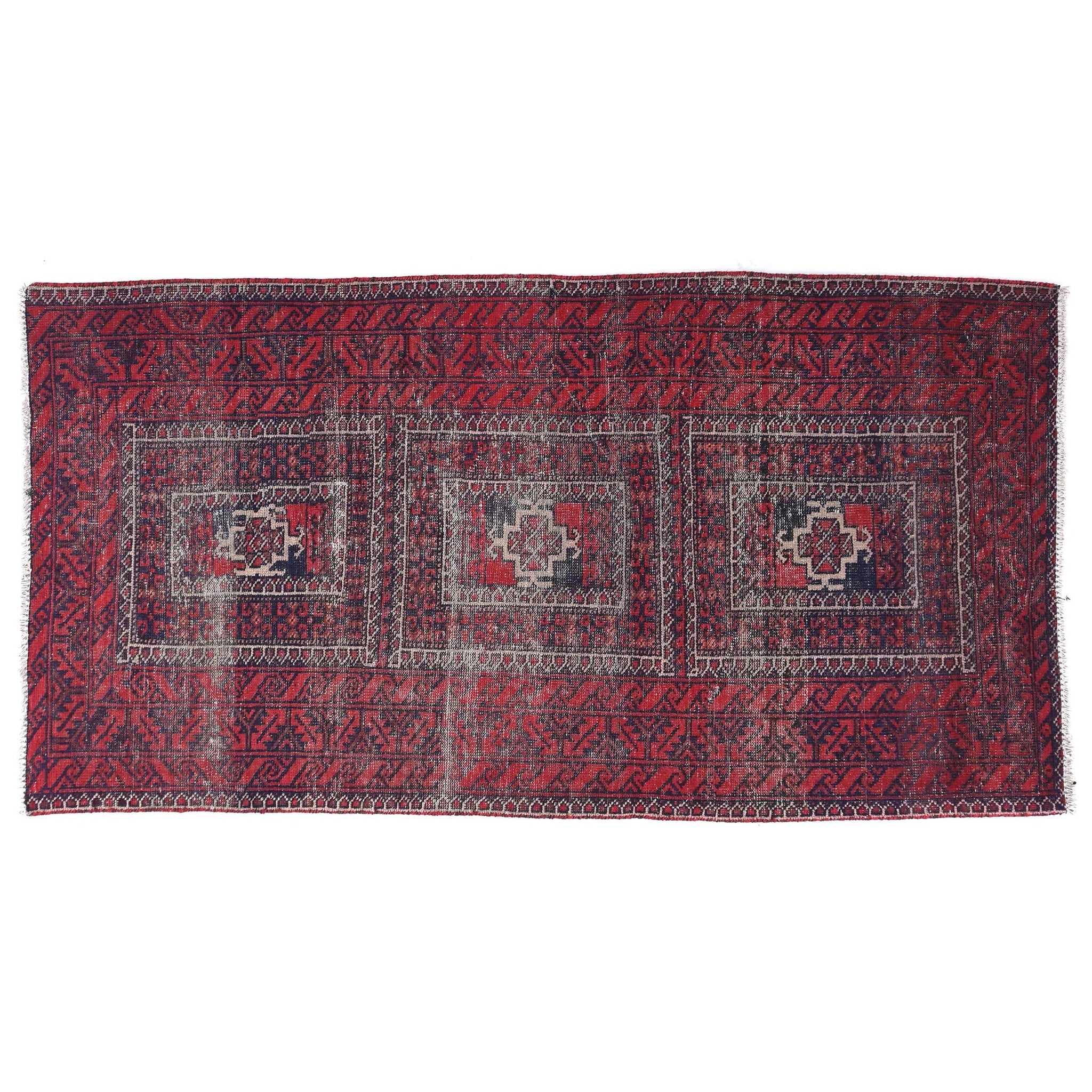 Red and black patterned rug on a white background