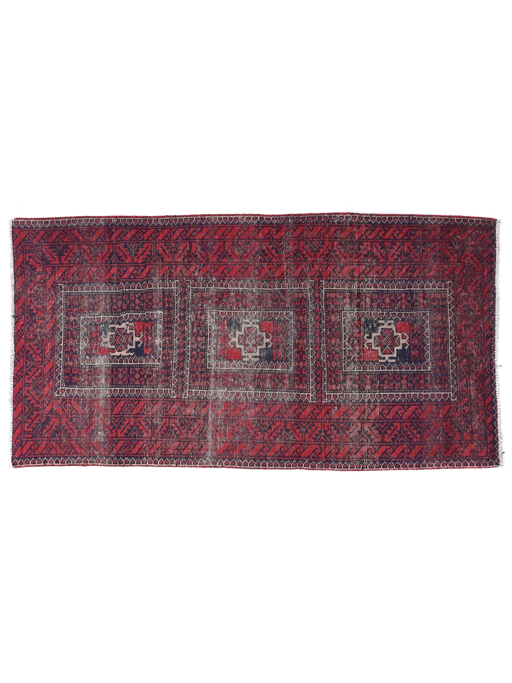 Red and black patterned rug on a white background