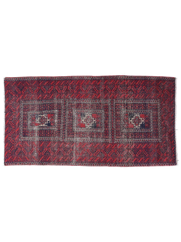 Red and black patterned rug on a white background