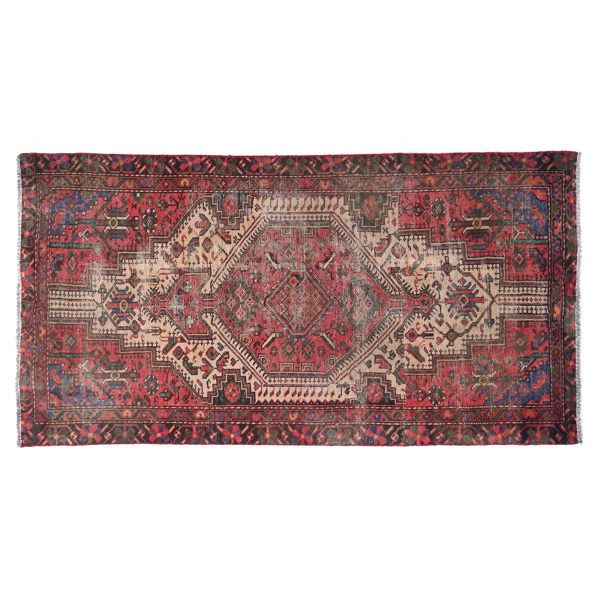 Vintage rug with intricate patterns on a white background