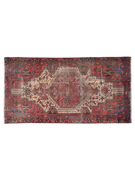Vintage rug with intricate patterns on a white background
