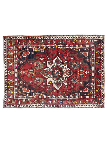 Decorative rug with intricate patterns on a white background