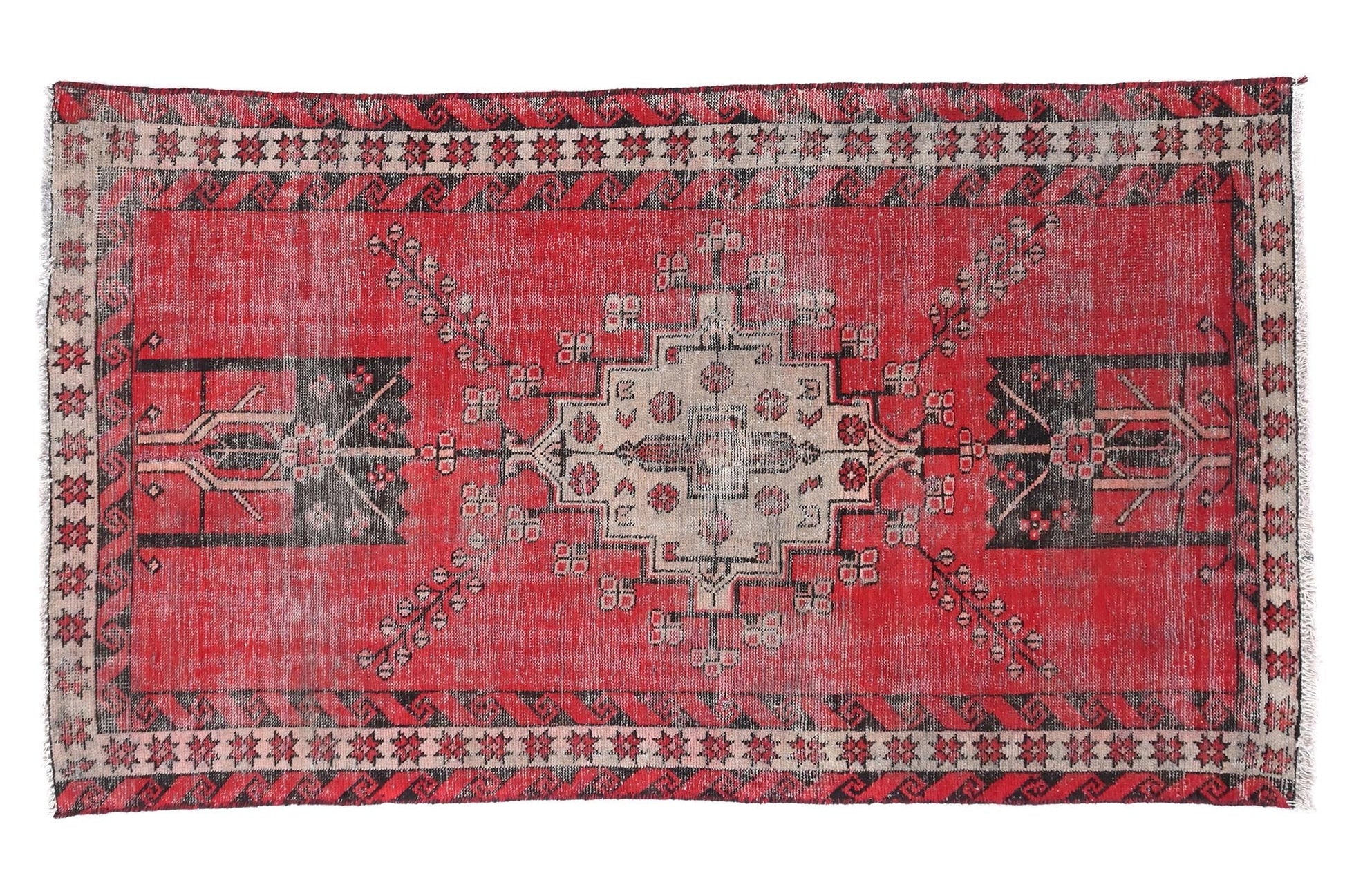 Red patterned rug with geometric design on a white background