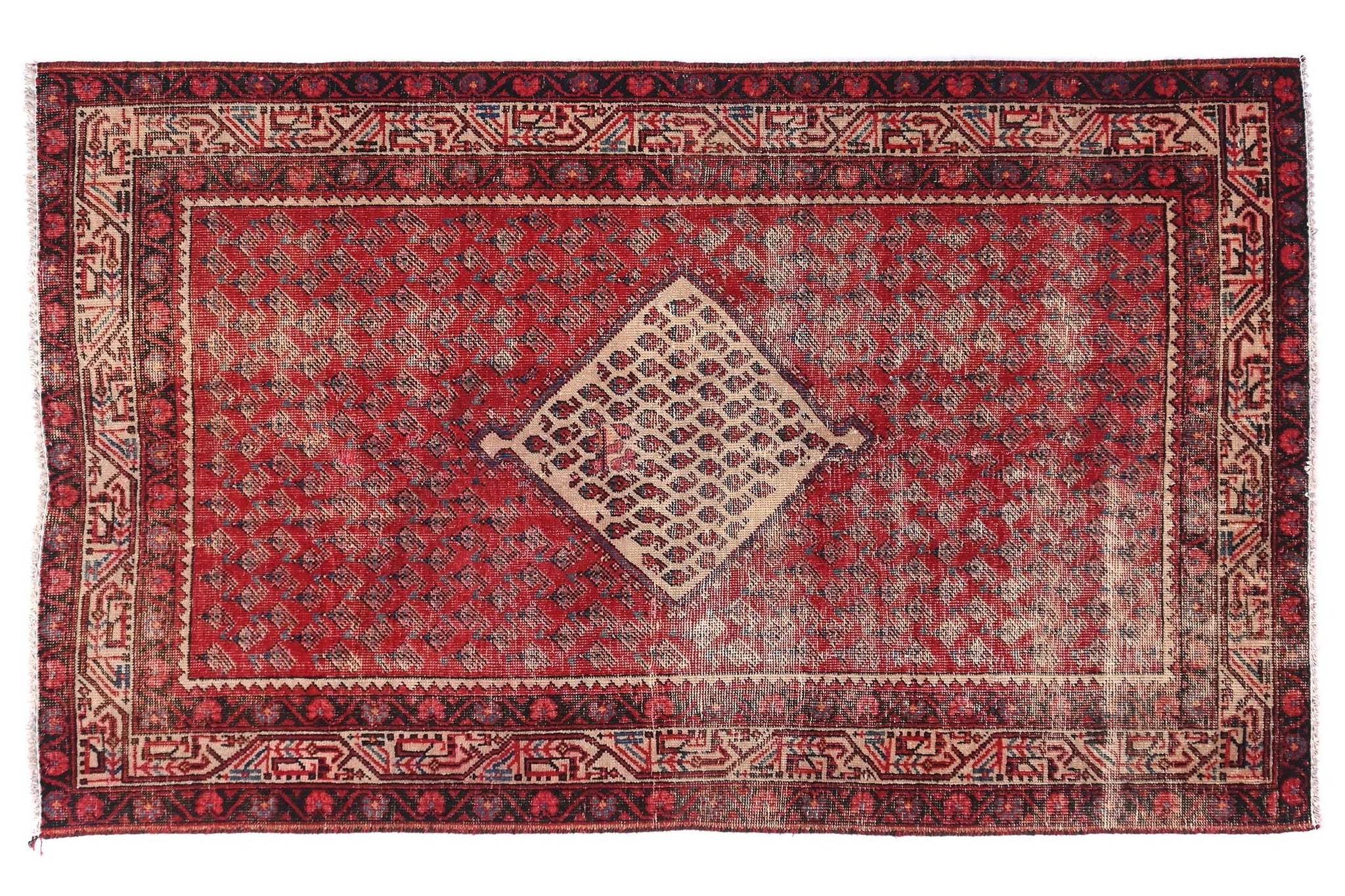 Red and brown patterned rug on a white background