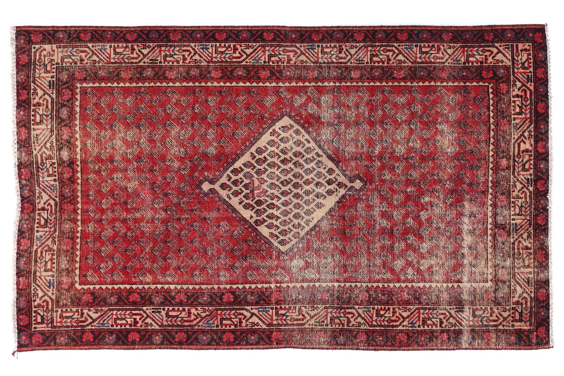Red and brown patterned rug on a white background