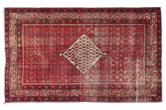 Red and brown patterned rug on a white background