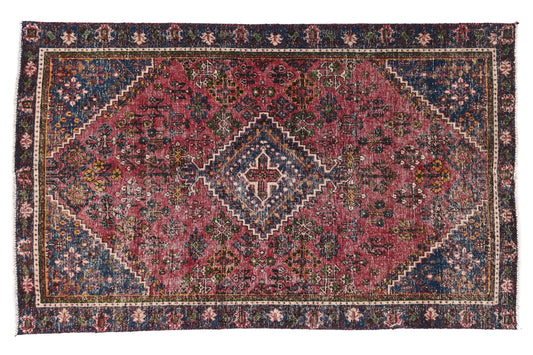 Decorative rug with intricate patterns on a white background