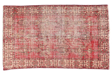 Vintage-style rug with red and beige pattern on a white background