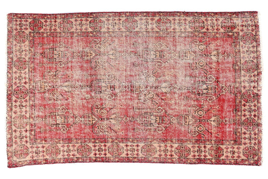 Vintage-style rug with red and beige pattern on a white background