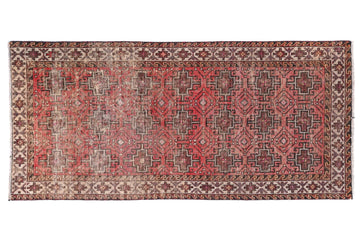 Decorative rug with intricate patterns on a white background