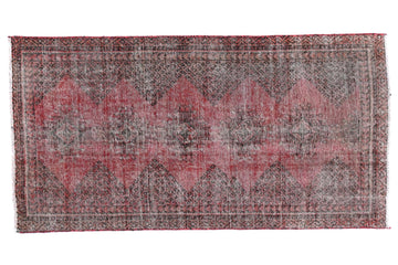 Rectangular rug with a patterned design on a white background