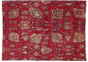 Red patterned rug with intricate designs on a white background