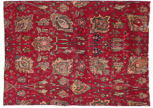 Red patterned rug with intricate designs on a white background