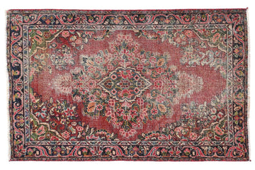 Vintage-style rug with intricate patterns on a white background