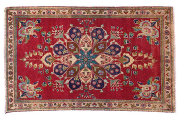 Decorative rug with intricate patterns on a red background