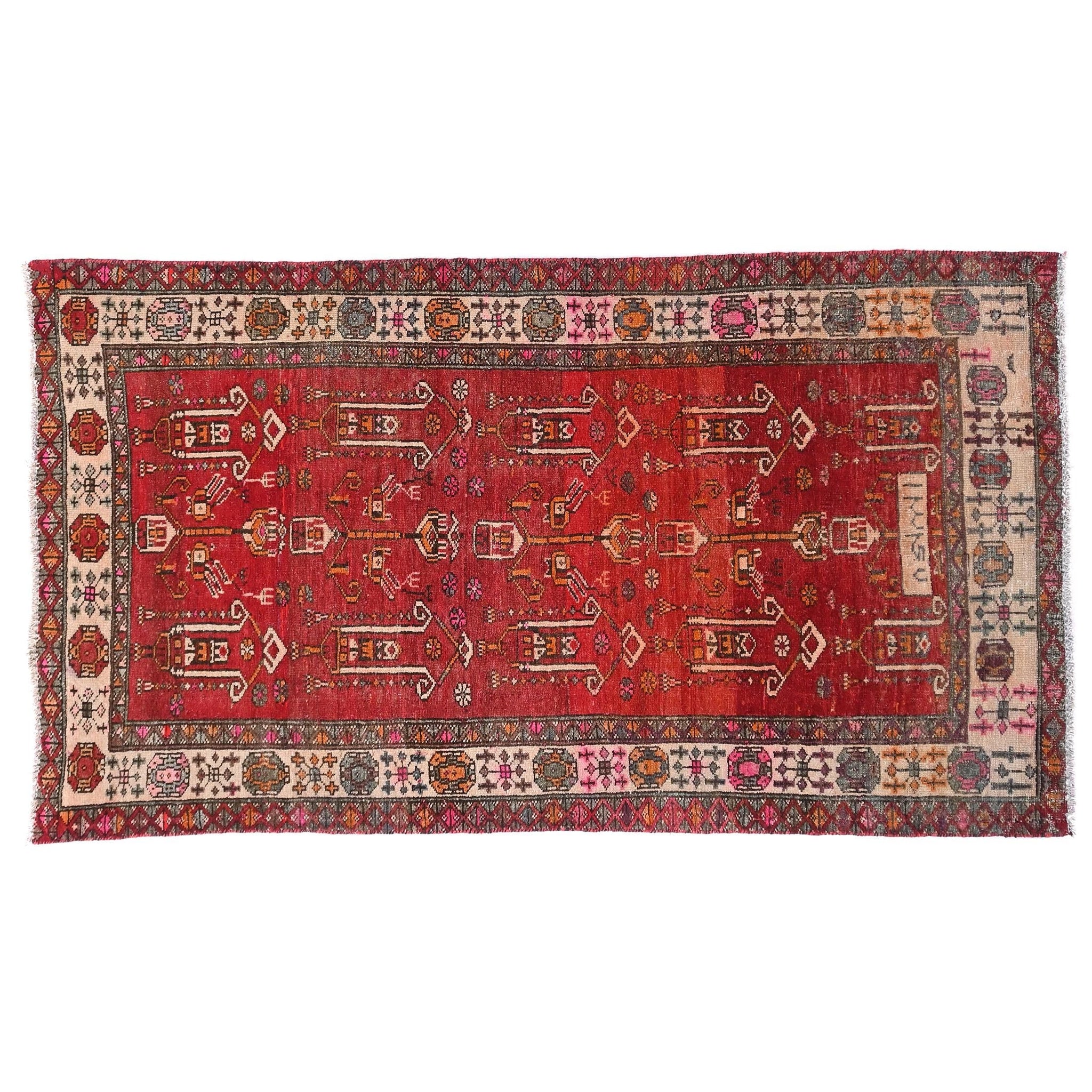 Red patterned rug with intricate designs on a white background