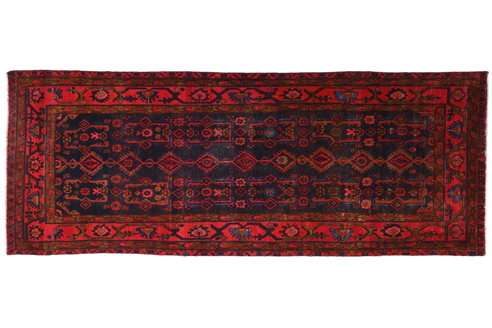Red and black patterned rug on a white background