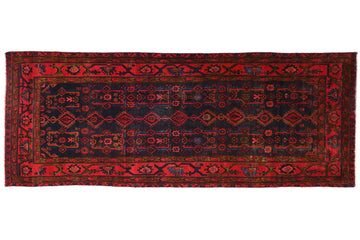 Red and black patterned rug on a white background
