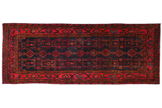 Red and black patterned rug on a white background