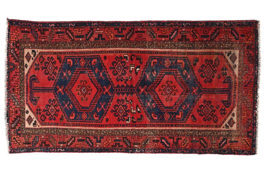 Red and black patterned rug on a white background