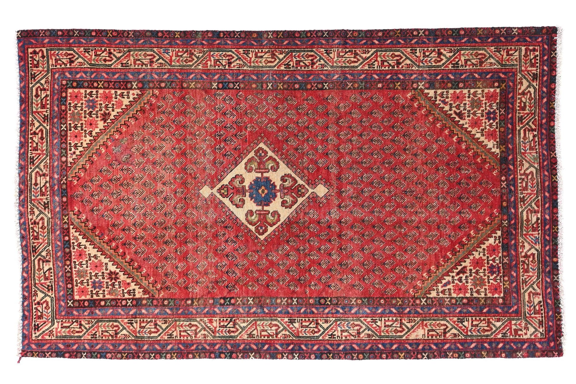 Red patterned rug with intricate designs on a white background