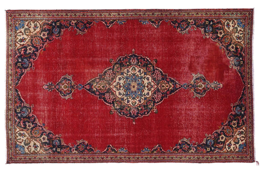 Decorative red rug with intricate patterns on a white background
