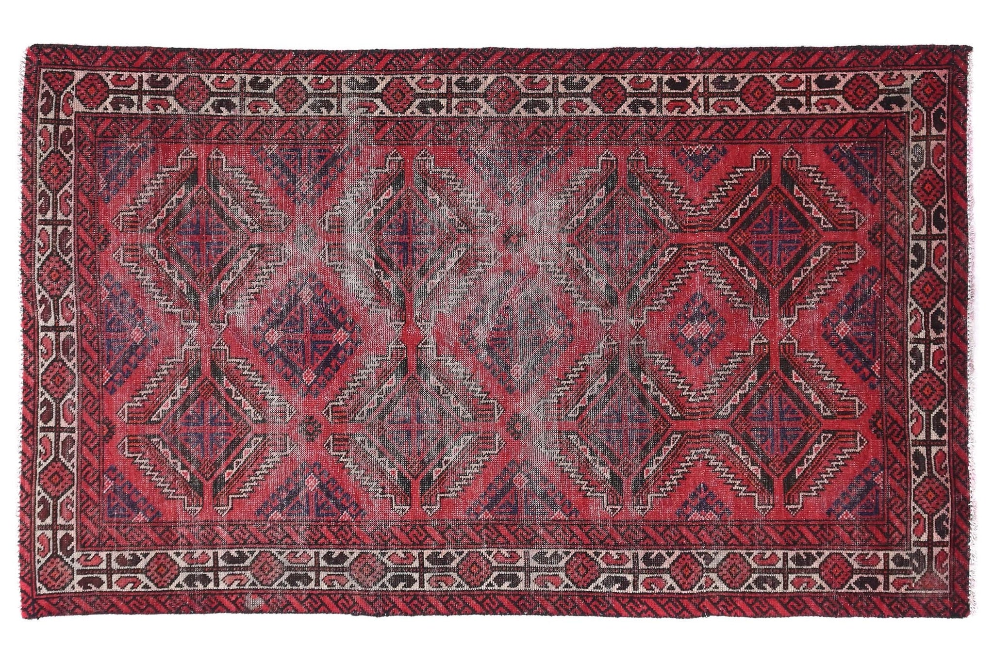 Red and black patterned rug on a white background