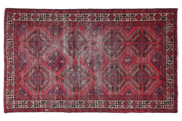 Red and black patterned rug on a white background