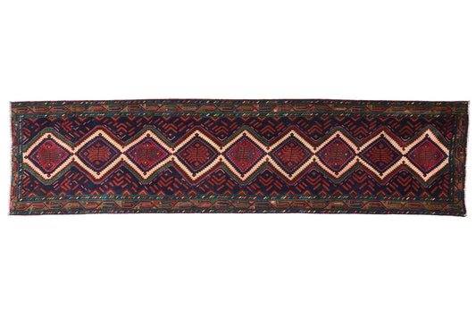 Long, narrow rug with geometric pattern on a white background