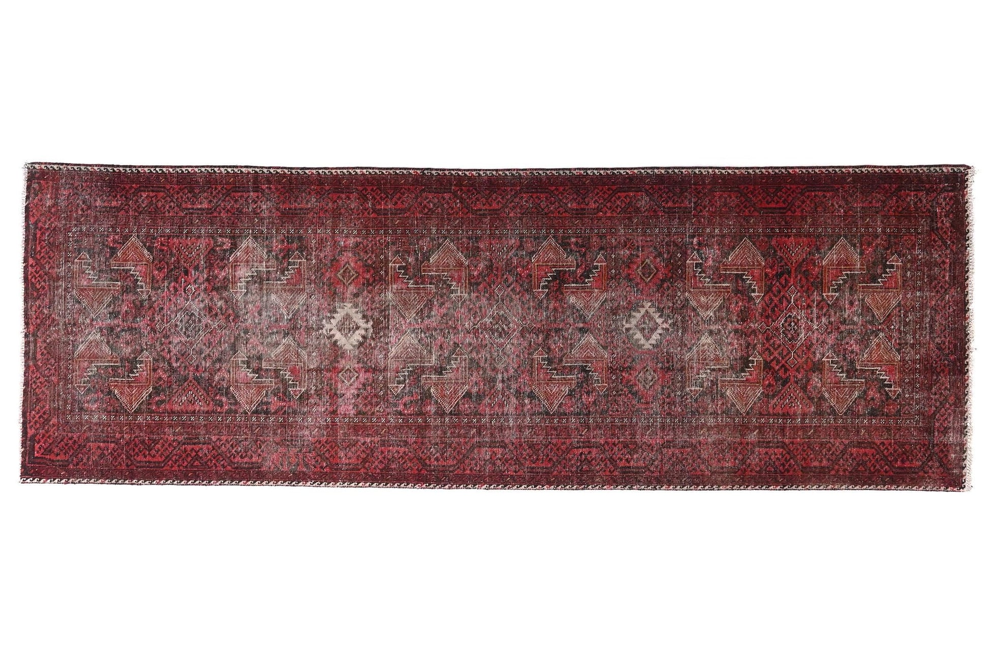 Long, narrow red rug with intricate patterns on a white background
