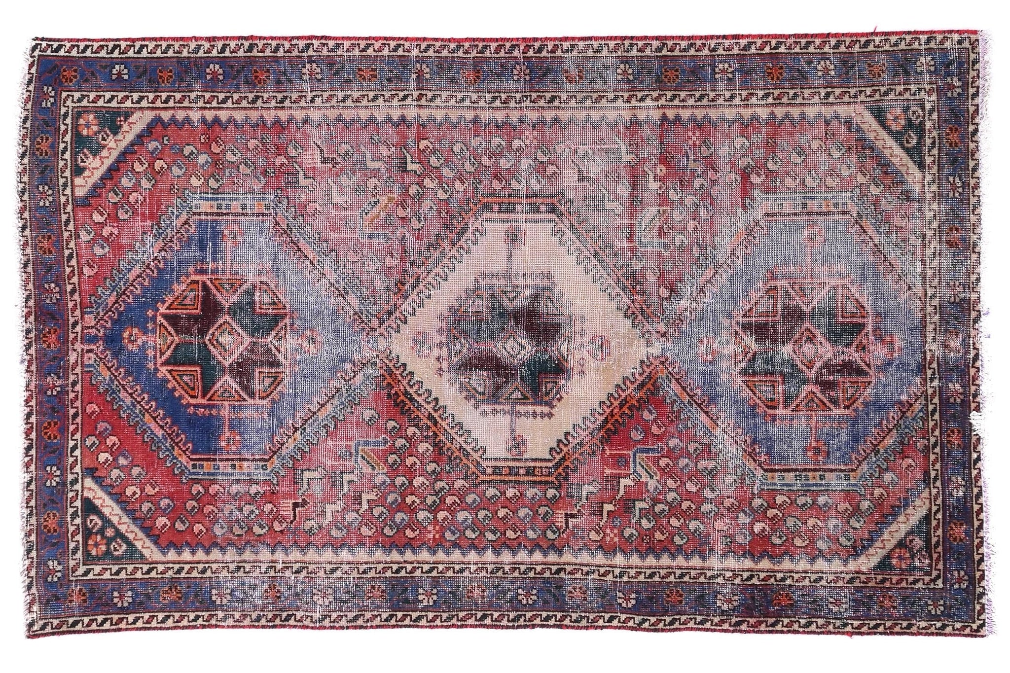 Vintage-style rug with geometric pattern on a white background
