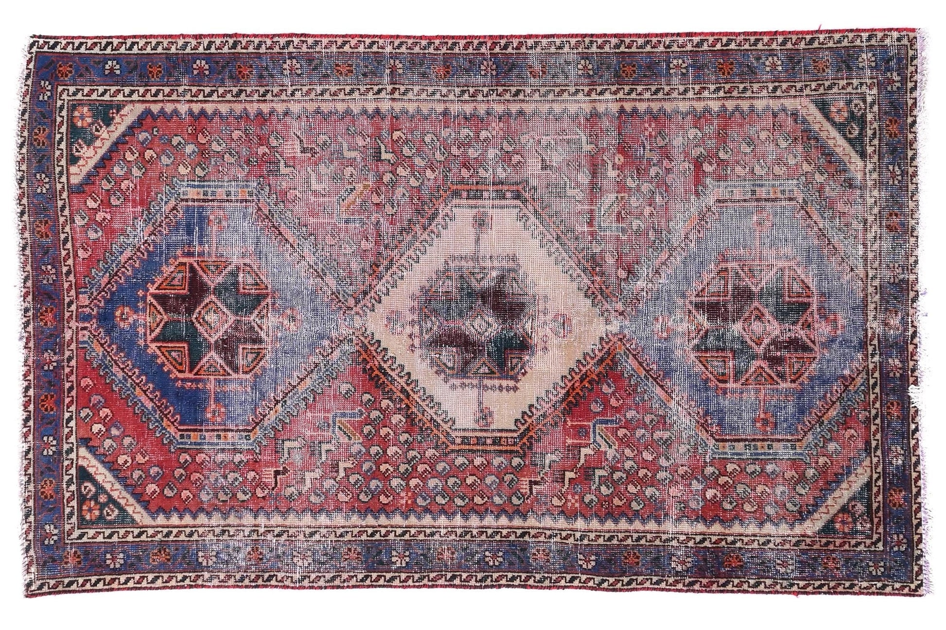 Vintage-style rug with geometric pattern on a white background