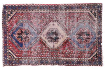 Vintage-style rug with geometric pattern on a white background