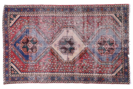 Vintage-style rug with geometric pattern on a white background