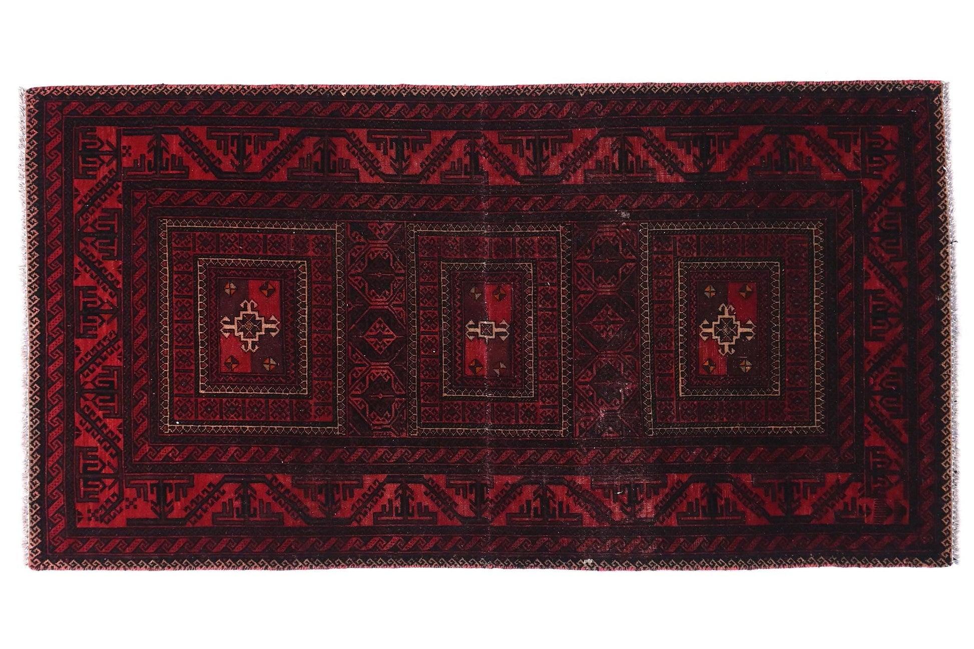 Red and black patterned rug on a white background