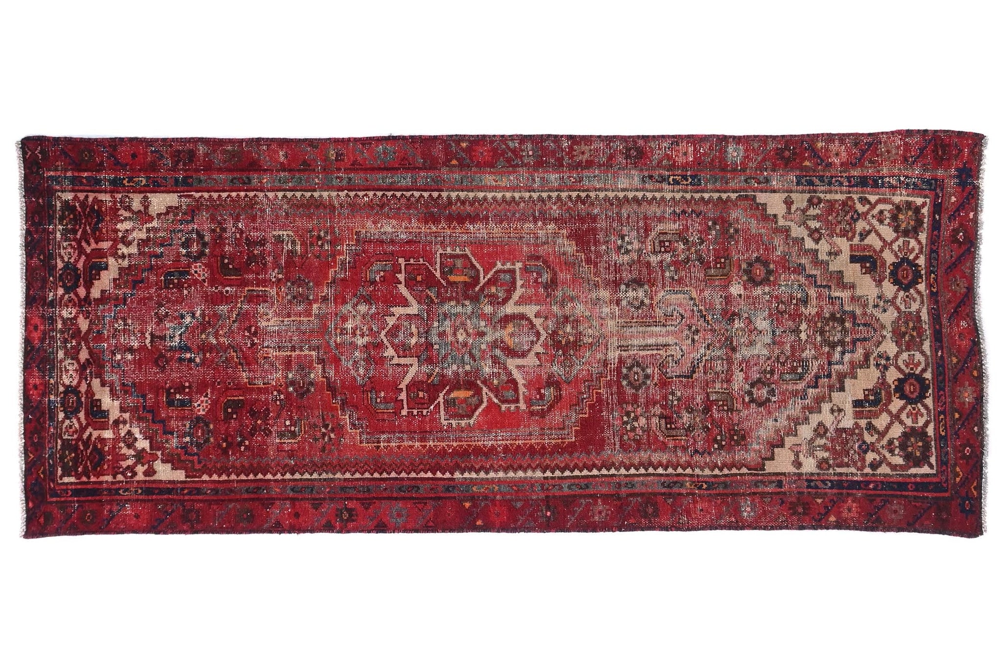 Vintage red and brown patterned rug on a white background