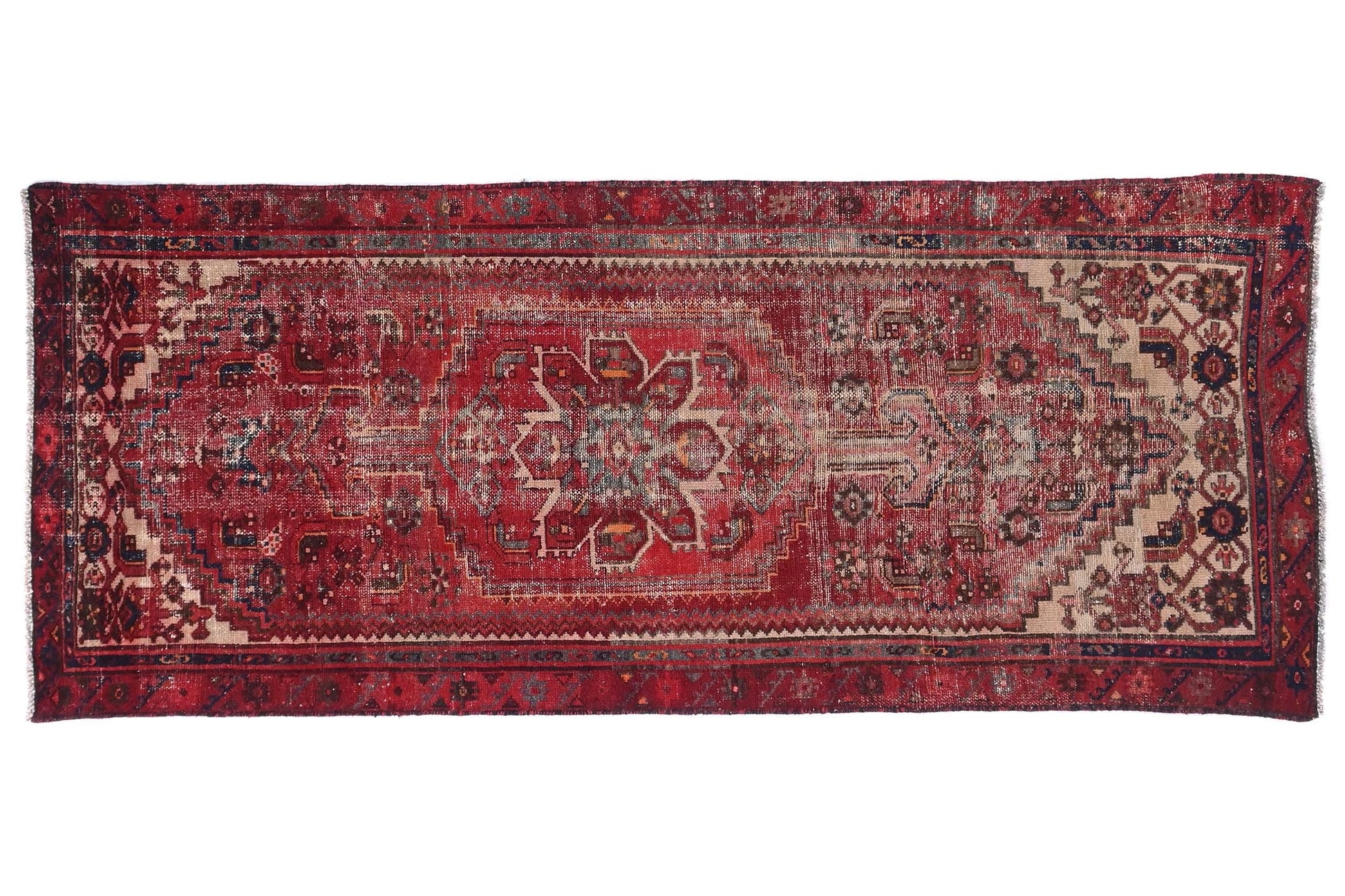 Vintage red and brown patterned rug on a white background