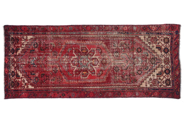 Vintage red and brown patterned rug on a white background
