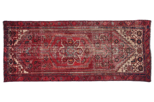 Vintage red and brown patterned rug on a white background