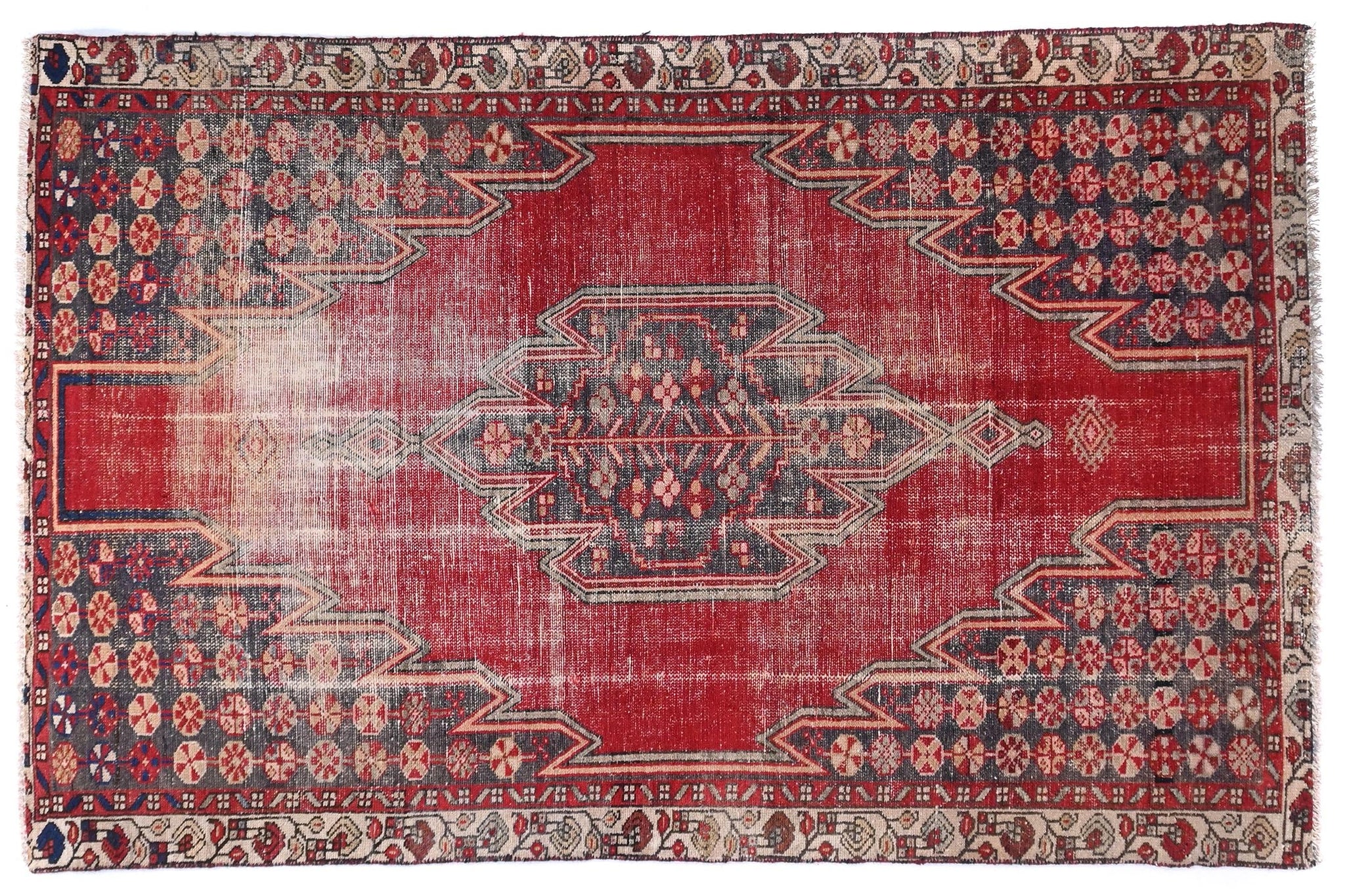 Red patterned rug on a white background