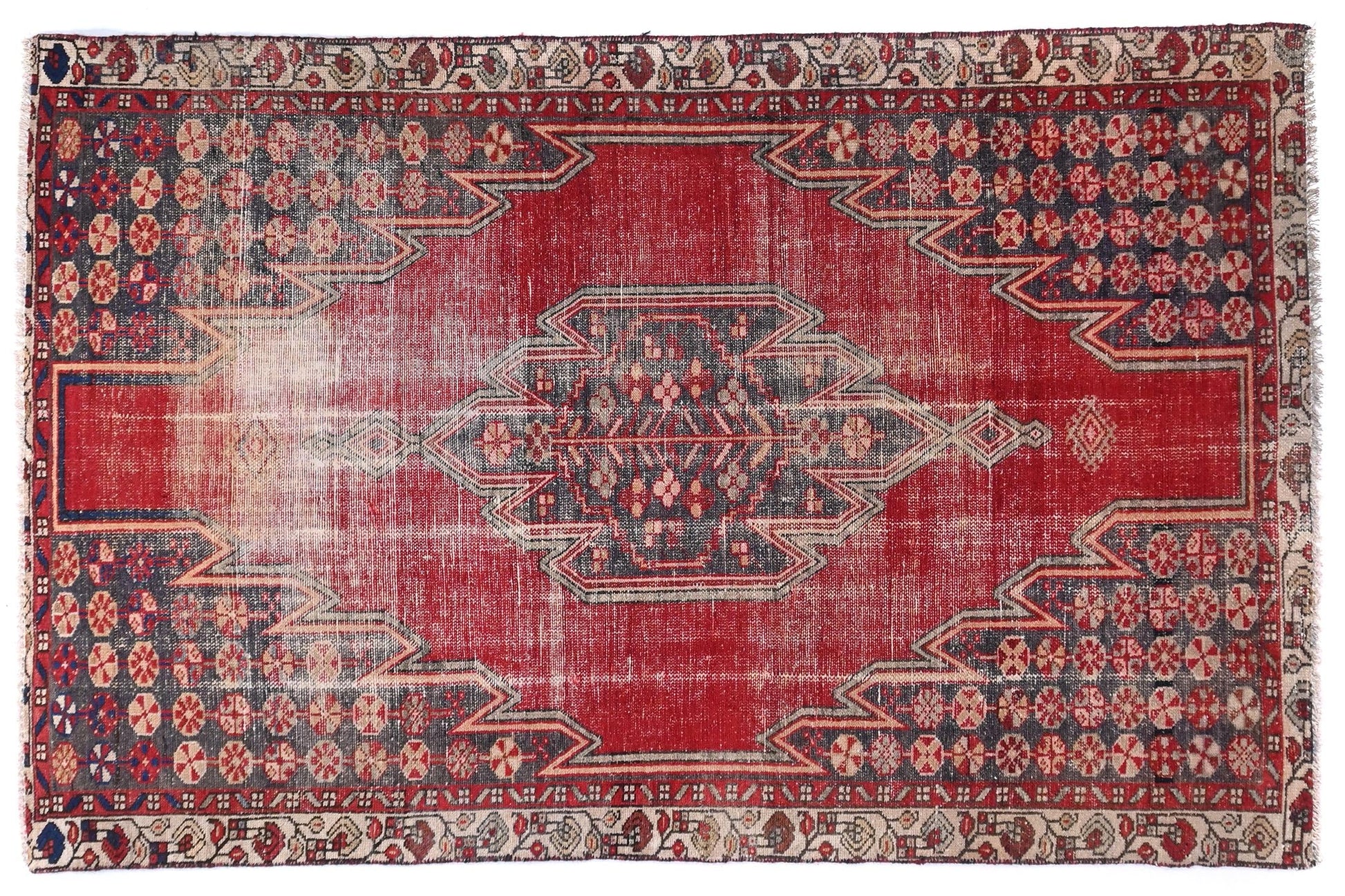 Red patterned rug on a white background