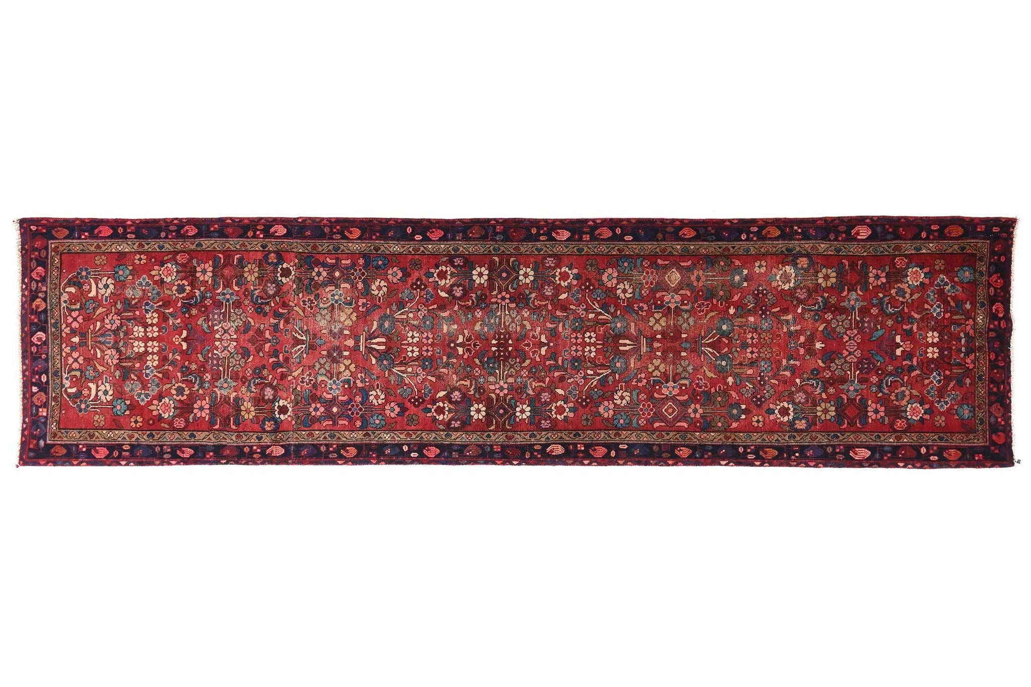 Long, narrow patterned rug on a white background