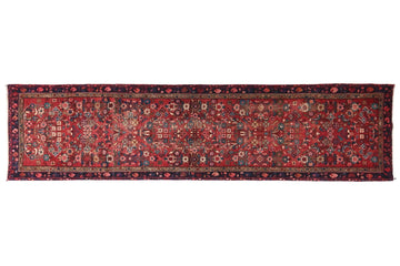 Long, narrow patterned rug on a white background