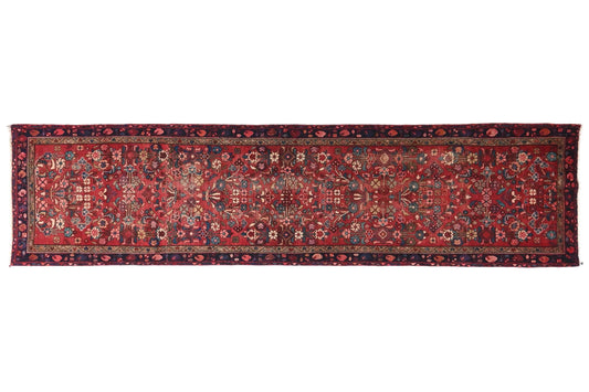 Long, narrow patterned rug on a white background